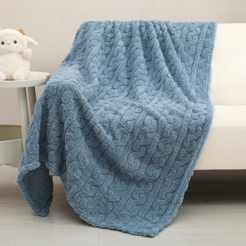Couverture bébé Nuage bleue déployée sur un fauteuil dans une chambre