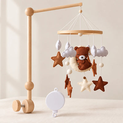Pack Escale sur la Lune : mobile ours brun aux yeux fermés sur une lune écrue, support en bois et boîte musicale blanche.