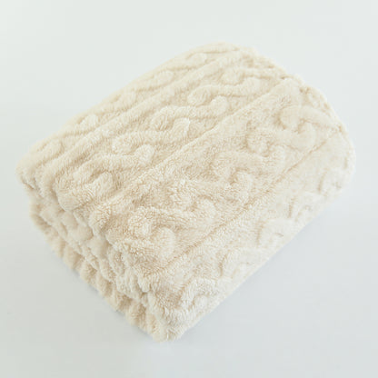 Couverture bébé Nuage crème pliée montrant sa texture douce et son relief ondulé