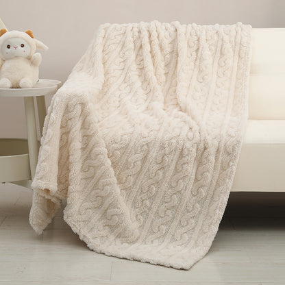 Couverture bébé Nuage crème déployée sur un fauteuil avec motif ondulé