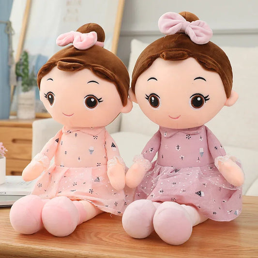 les deux poupées chiffon rose et violet sont présentées sur une table